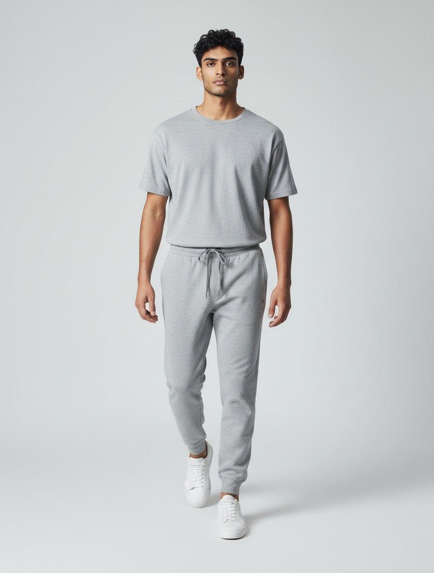CosmoOtaku unisex grey melange joggers in 260 GSM cotton with a tapered fit, ribbed cuffs, and drawstring waistband.