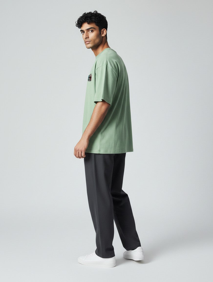 CosmoOtaku jade green unisex crew neck t-shirt with anime chest graphic, worn by a model in a side profile view.