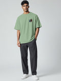 CosmoOtaku jade green unisex crew neck t-shirt with From Student to Legend anime chest graphic on a male model