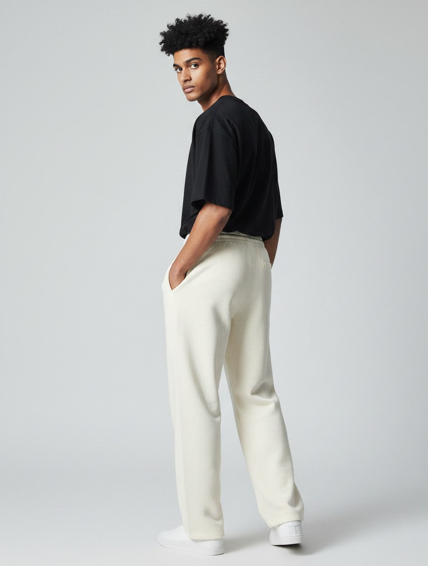 CosmoOtaku unisex loose-fit off-white sweatpants with drawstring waist and pockets worn by a model