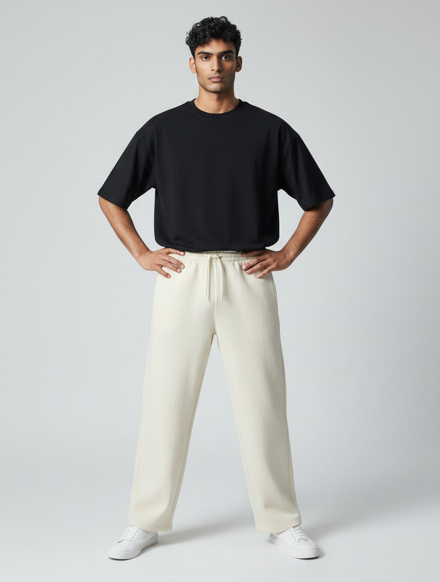 CosmoOtaku model wearing loose-fit off-white cotton terry sweatpants with a drawstring waist and black t-shirt