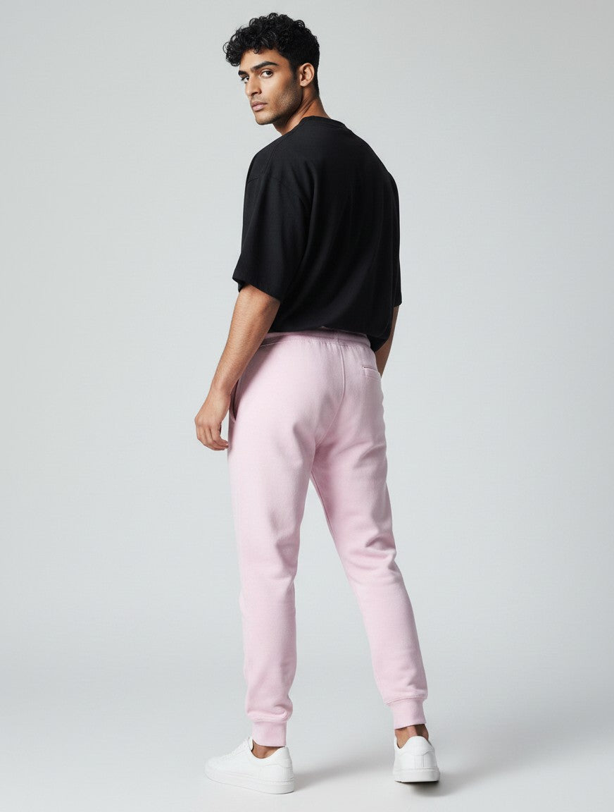 A model wearing CosmoOtaku pastel pink 100% cotton joggers with a relaxed tapered fit and ribbed cuffs, back view.