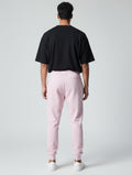CosmoOtaku unisex pastel pink cotton joggers with a relaxed tapered fit and ribbed cuffs, shown from the back view.