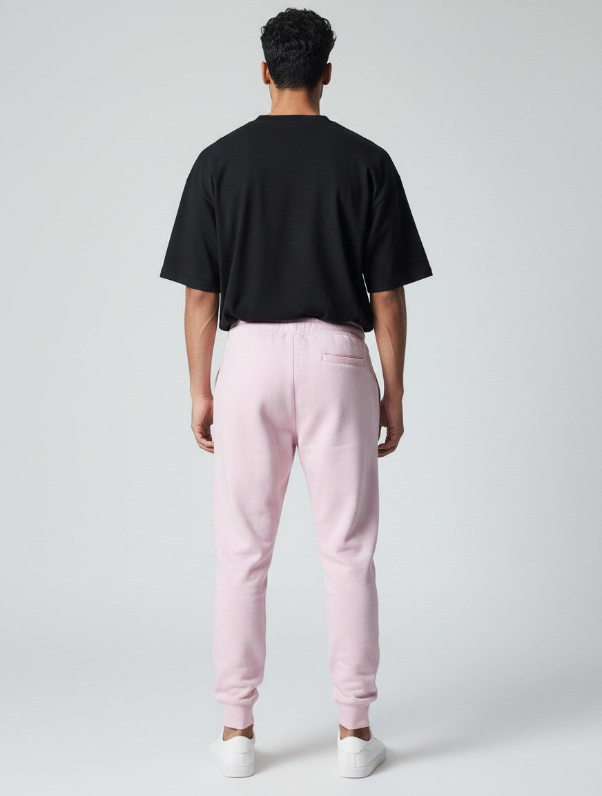 CosmoOtaku unisex pastel pink cotton joggers with a relaxed tapered fit and ribbed cuffs, shown from the back view.