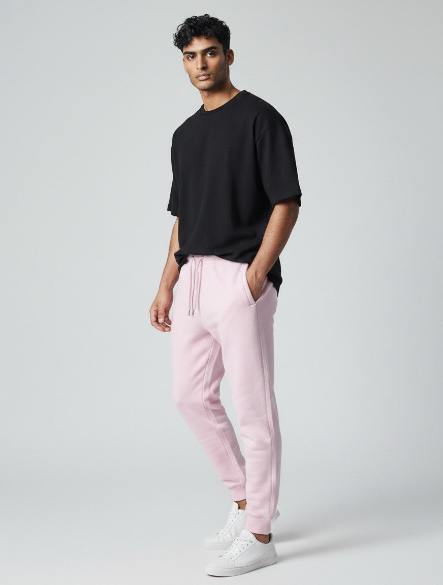 CosmoOtaku unisex pastel pink cotton joggers with a relaxed tapered fit, ribbed cuffs, and drawstring waist on a model