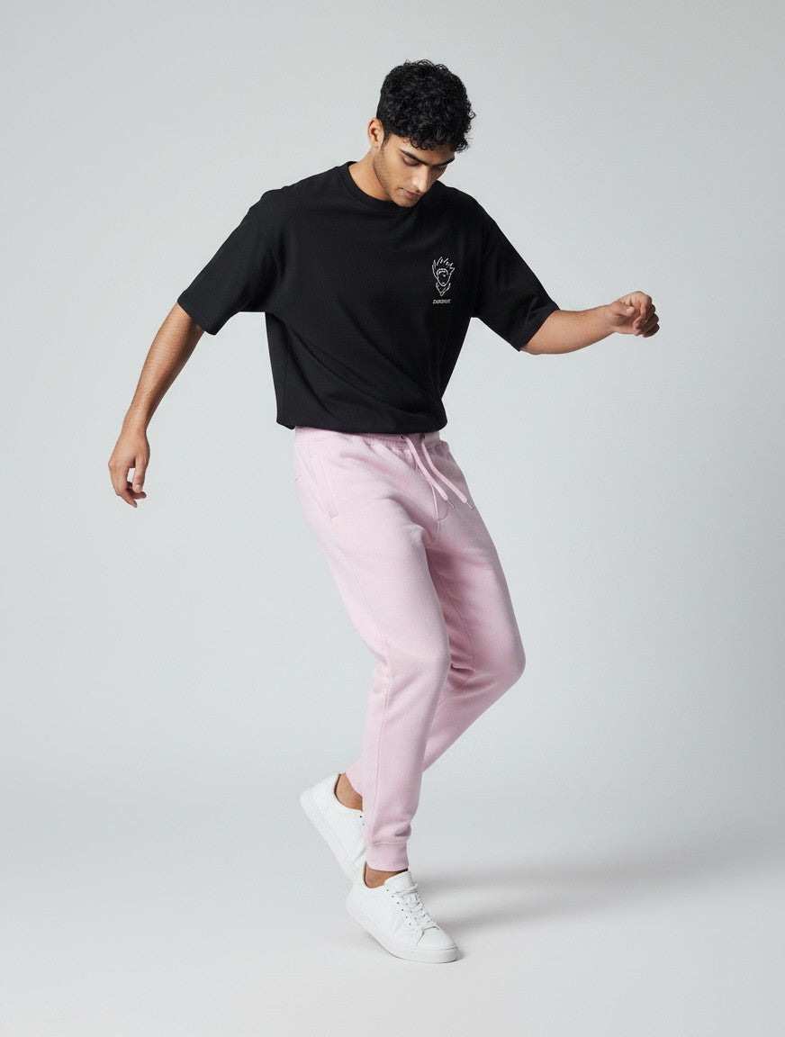 CosmoOtaku model wearing pastel pink 100% cotton unisex joggers with a relaxed tapered fit and drawstring waist